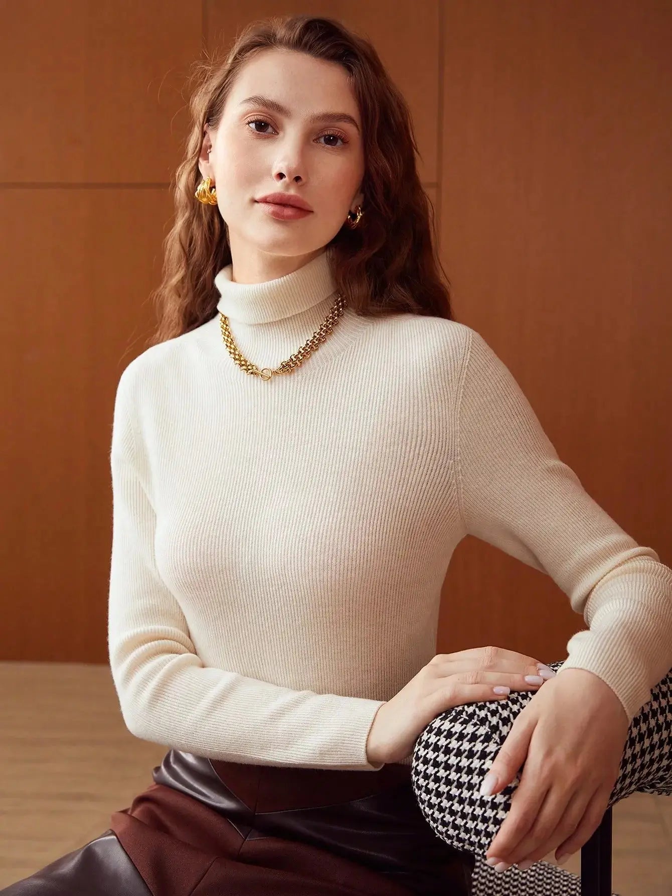 Pull en laine pure à col roulé, conçu pour l'élégance et la chaleur. Coupe régulière avec manches longues, disponible en blanc cassé, beige et noir. Tricot à côtes offrant une élasticité moyenne. Idéal pour un style décontracté pendant les jours frais d'automne. Lavage à la main ou nettoyage à sec conseillé.