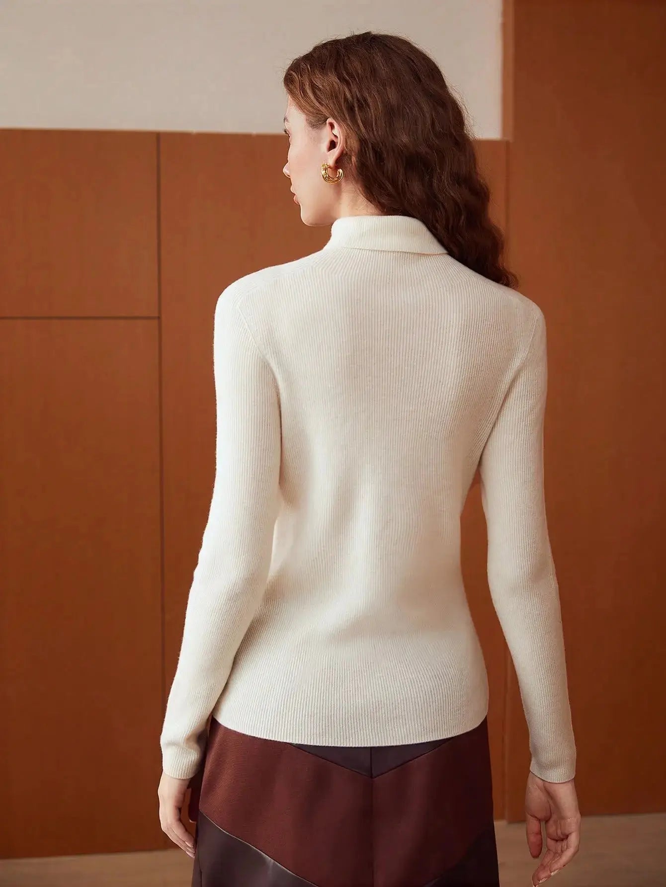 Pull en laine pure à col roulé, conçu pour l'élégance et la chaleur. Coupe régulière avec manches longues, disponible en blanc cassé, beige et noir. Tricot à côtes offrant une élasticité moyenne. Idéal pour un style décontracté pendant les jours frais d'automne. Lavage à la main ou nettoyage à sec conseillé.