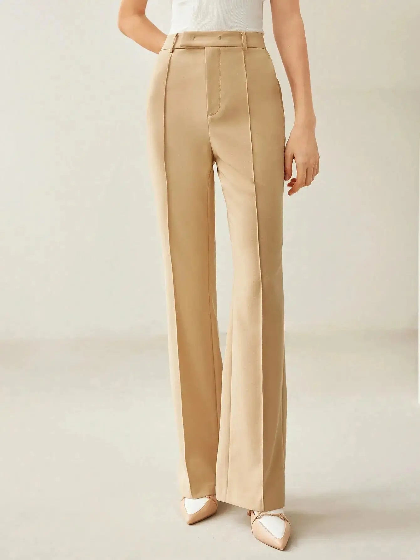 Pantalon évasé en tissu de haute qualité, alliant confort et élégance grâce à sa coupe régulière et sa taille haute. Confectionné en 92% polyester et 8% élasthanne, il présente des jambes évasées et des coutures avant pour une silhouette sophistiquée. Disponible en beige intemporel, il est doté de poches fonctionnelles et d'une fermeture par bouton. Nettoyage à sec recommandé pour préserver son aspect.