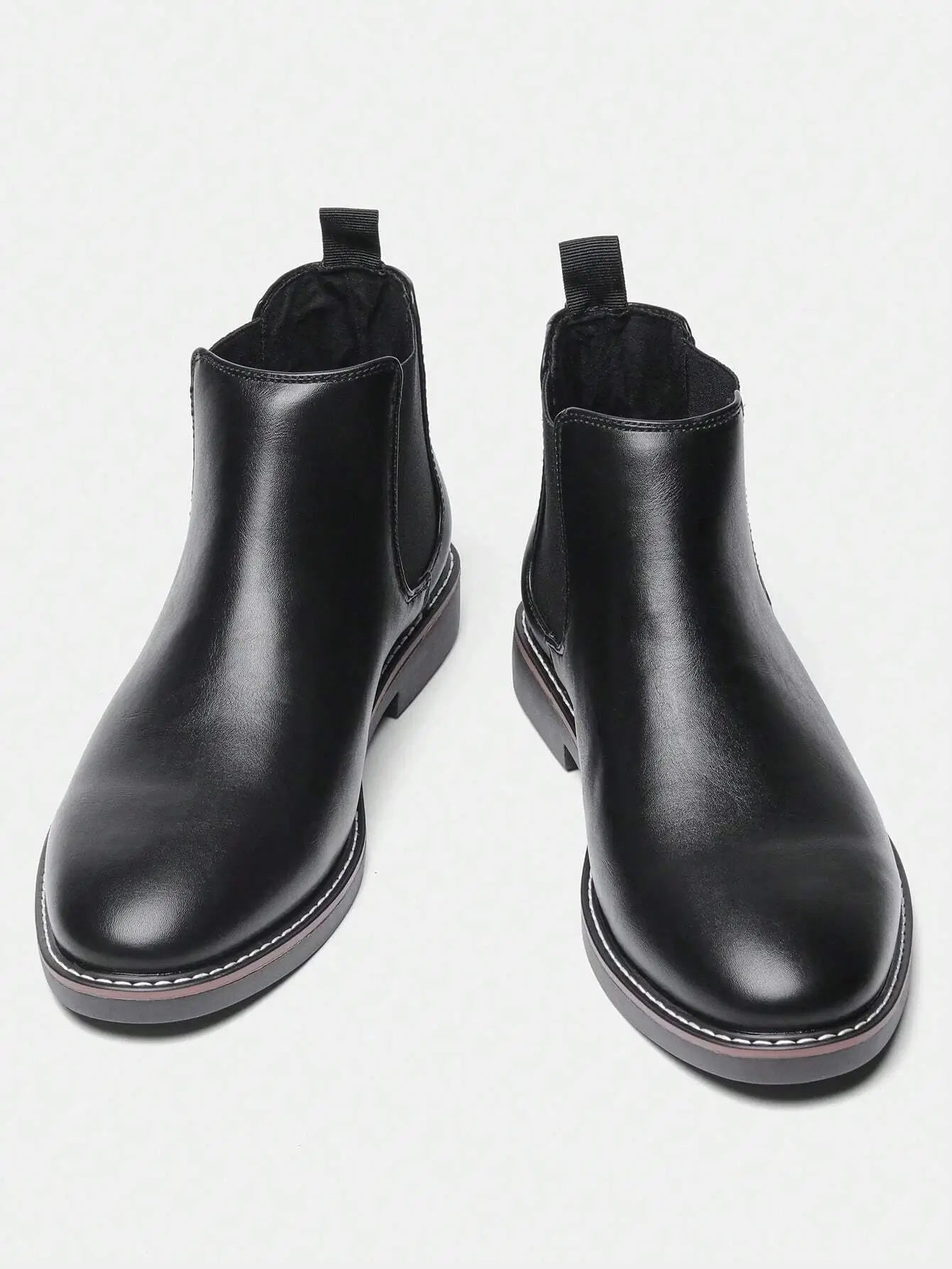 Bottes Chelsea classiques en cuir synthétique de haute qualité, disponibles en noir. Coupe ajustée avec tige haute. Panneaux élastiques et languette pour un enfilage facile, bout rond pour le confort. Semelle en caoutchouc robuste avec coutures visibles. Nettoyage à la main conseillé.
